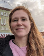 portait of smiling ginger woman with pink top